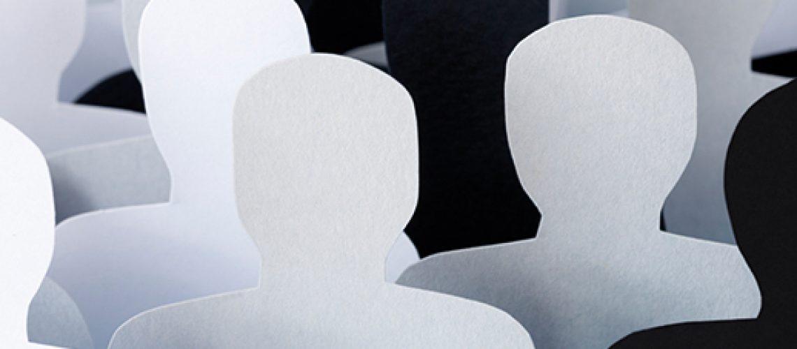 Lots of monochromatic men silhouettes made with paper for crowd concept